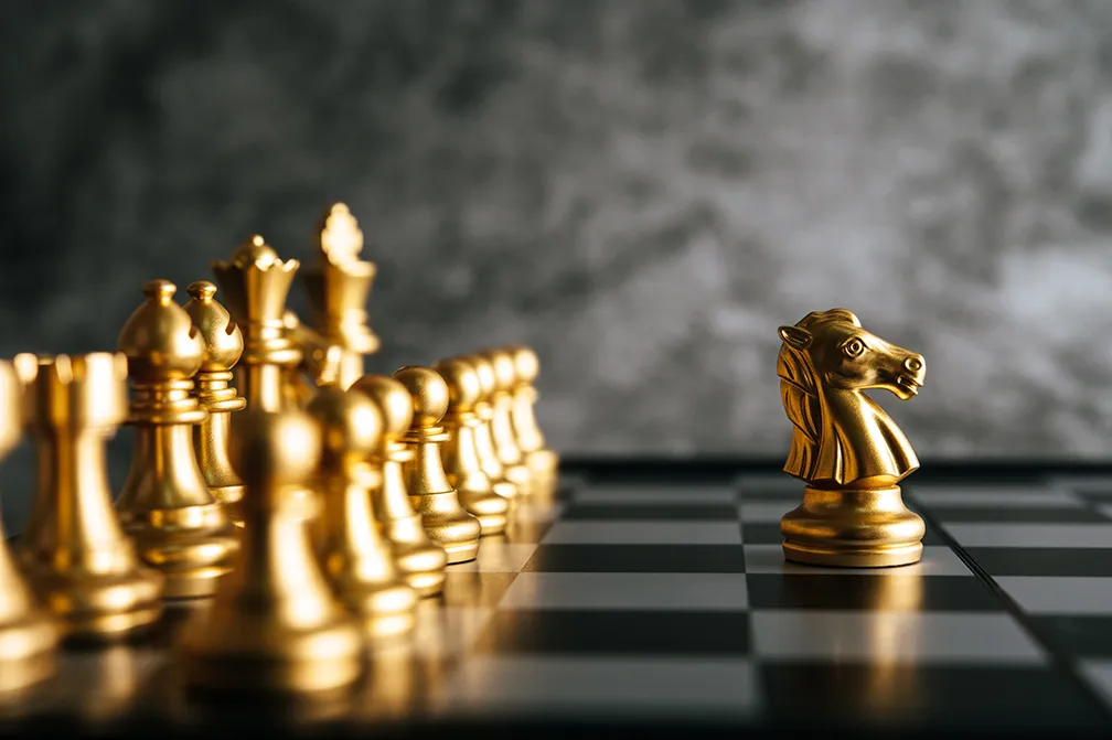 Gold chess king on a chessboard — a metaphor for business strategy